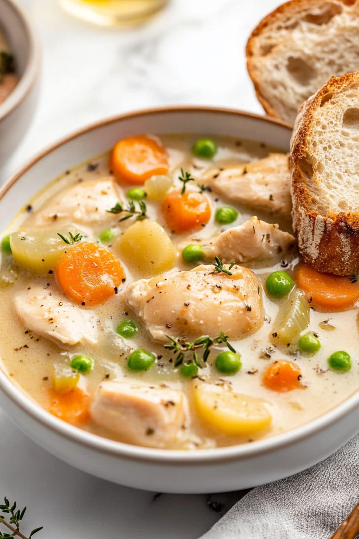 Chicken stew with potatoes, carrots and herbs in creamy white sauce.