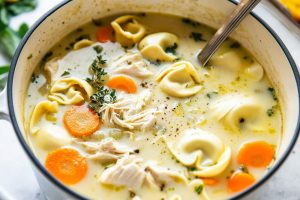 Chicken tortellini soup in a Dutch oven pot.