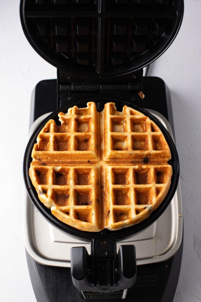 Freshly cooked chocolate chip waffle in a waffle iron