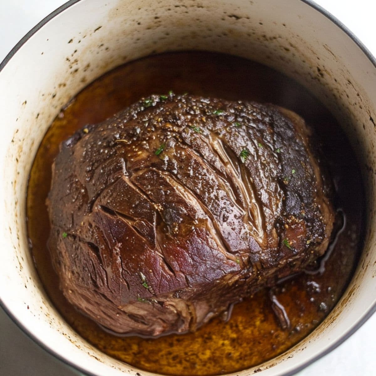 Seared chuck roast in a pot.