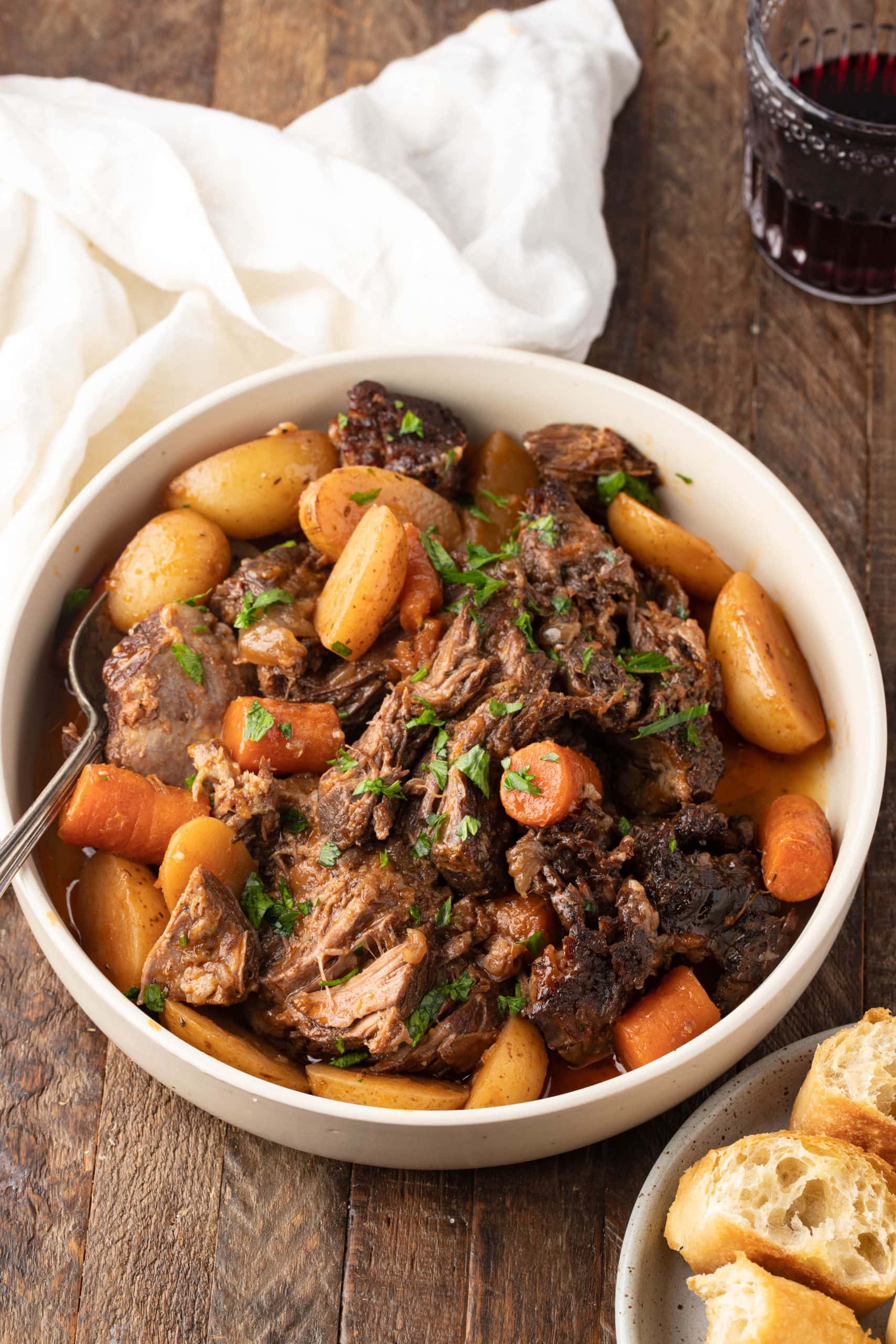 Pot roast in a bowl, with bread on the side