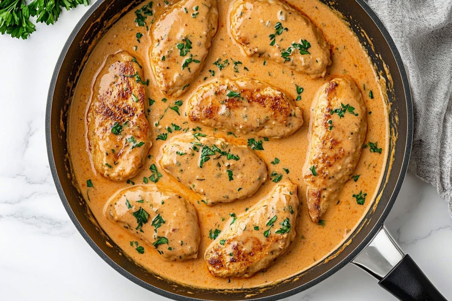 Chicken lazone served with a smooth, buttery cream sauce, topped with herbs.