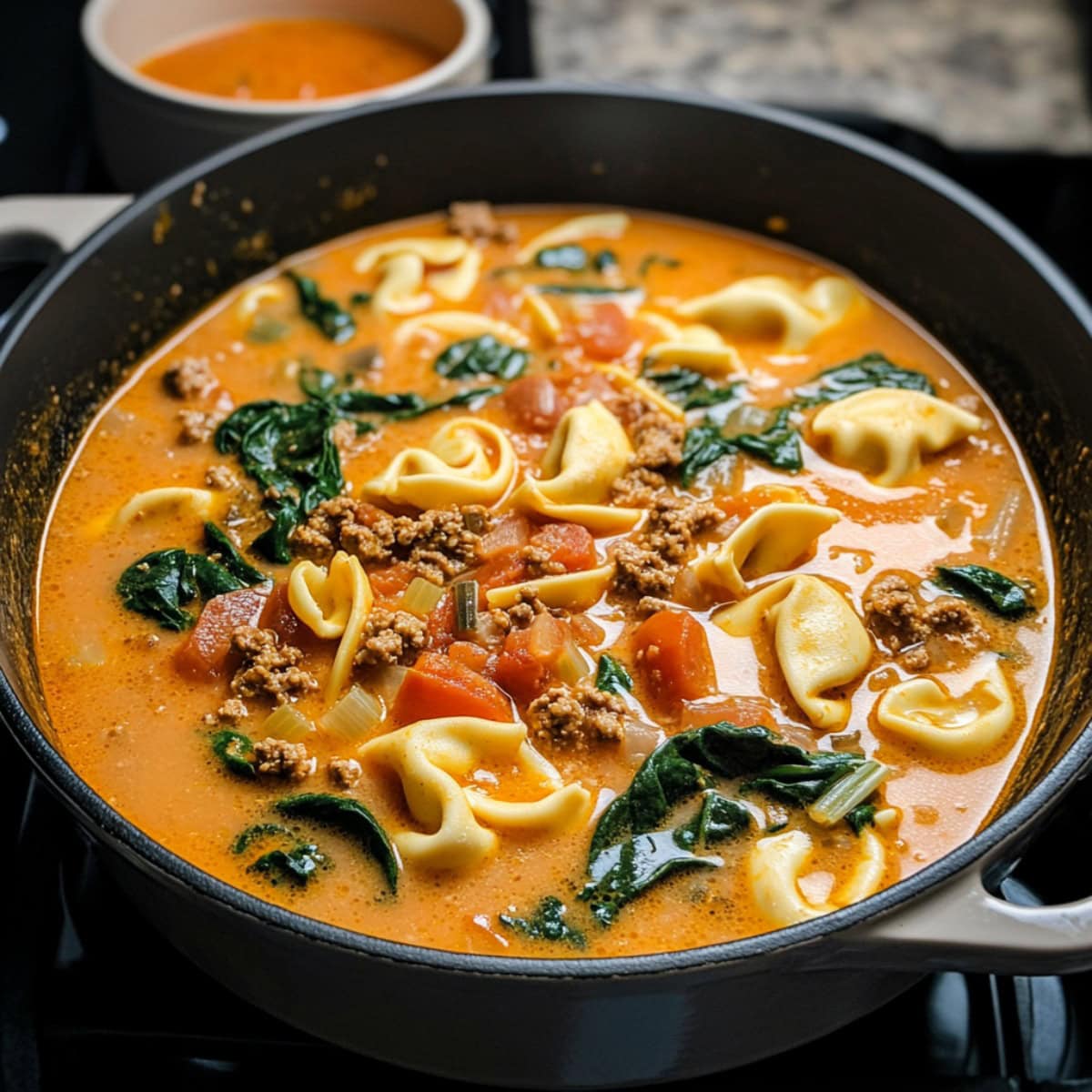 Creamy Sausage Tortellini Soup in a skillet