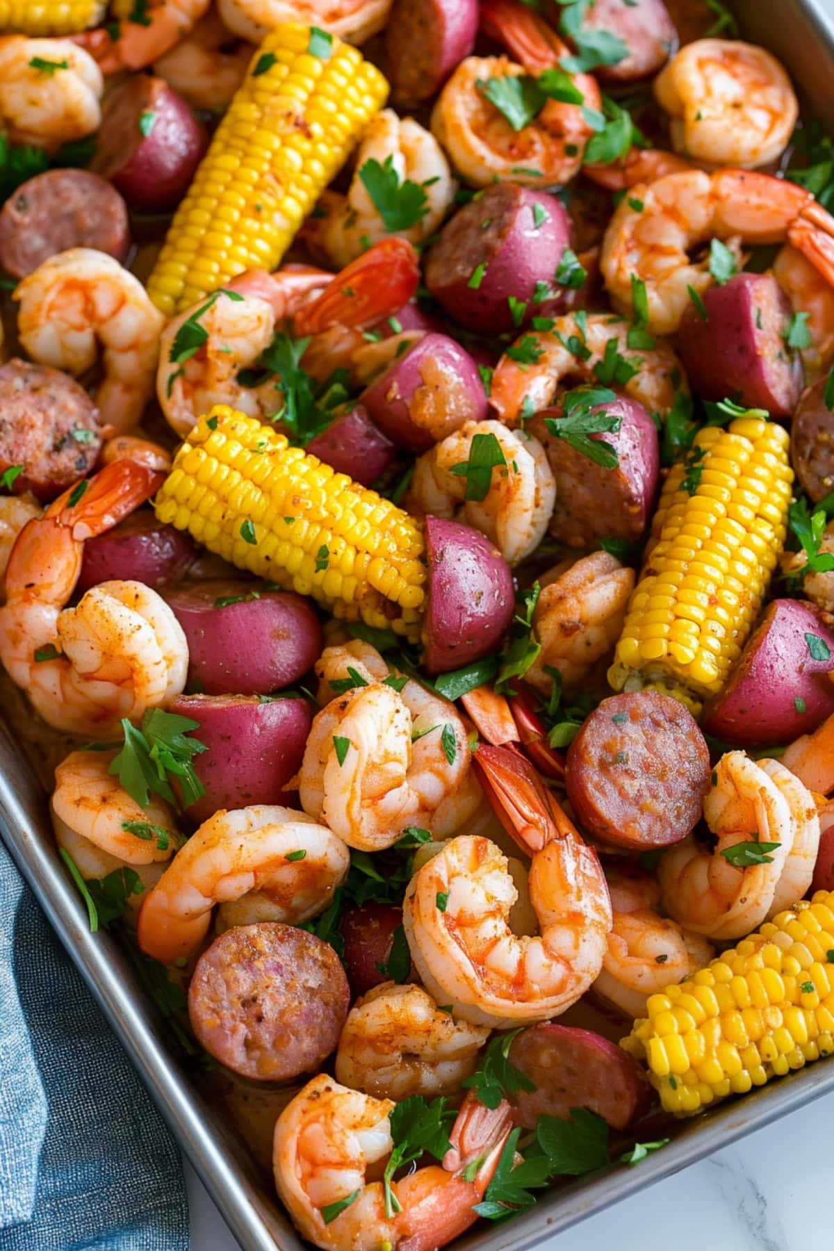 An overhead view of Frogmore stew with corn, sausage and red baby potatoes.