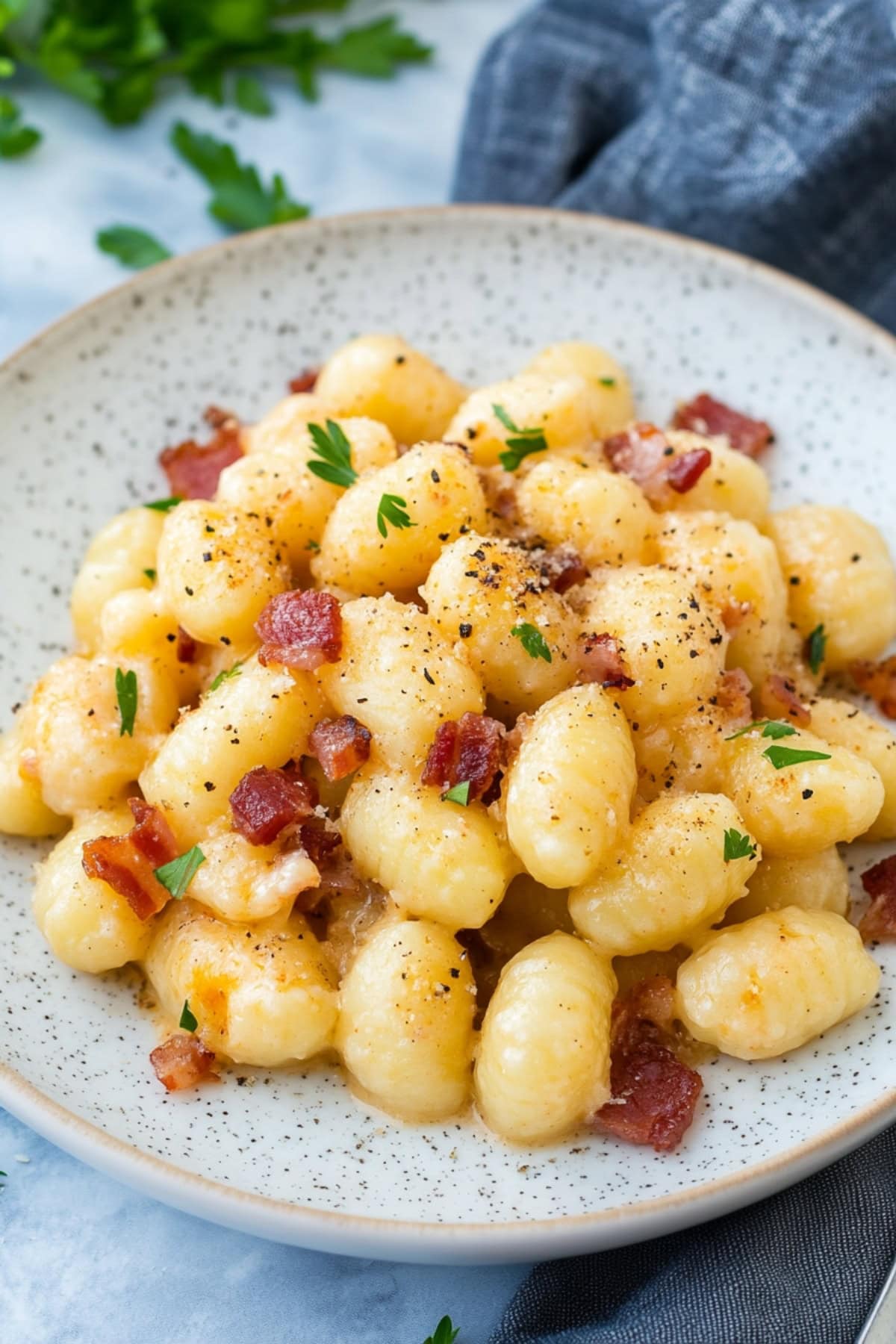 Cheesy gnocchi carbonara with pancetta and parsley.