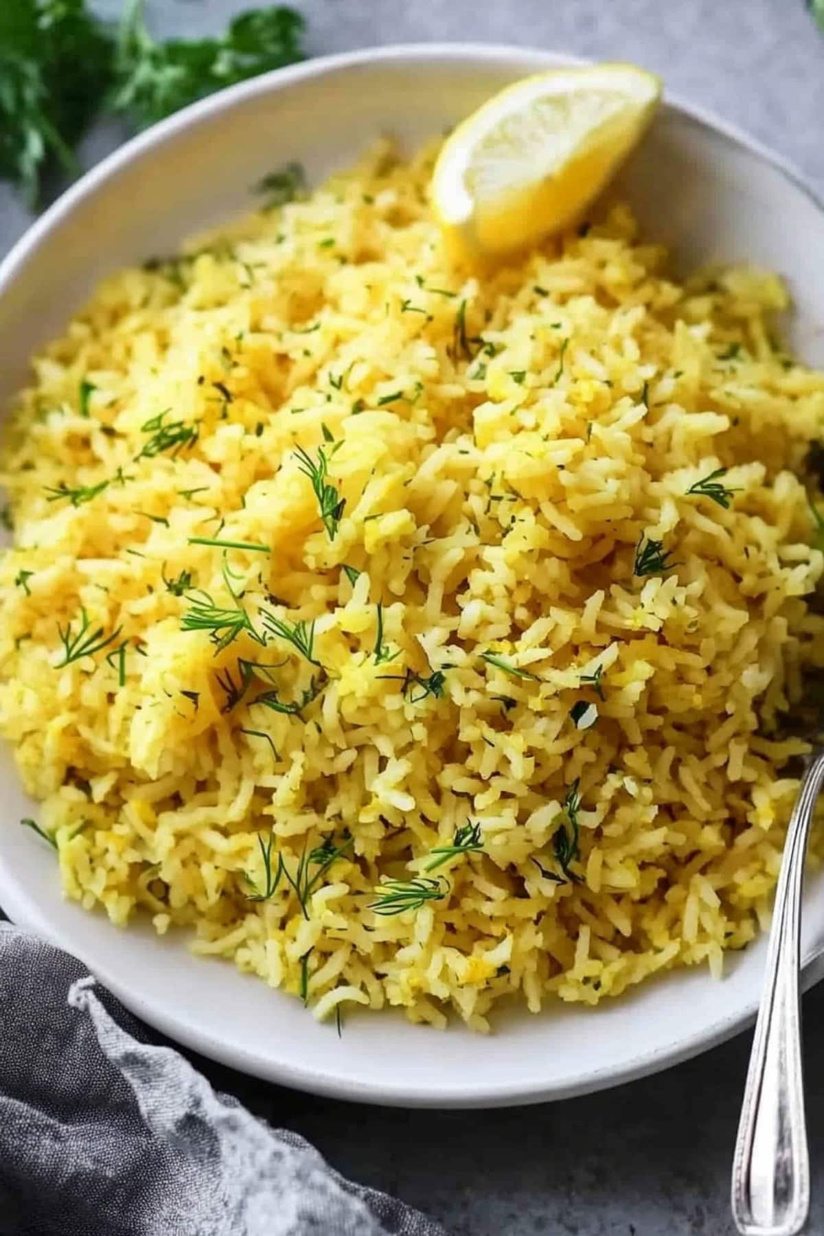 Plate of Greek lemon rice with a light zest of lemon and garnished with dill.