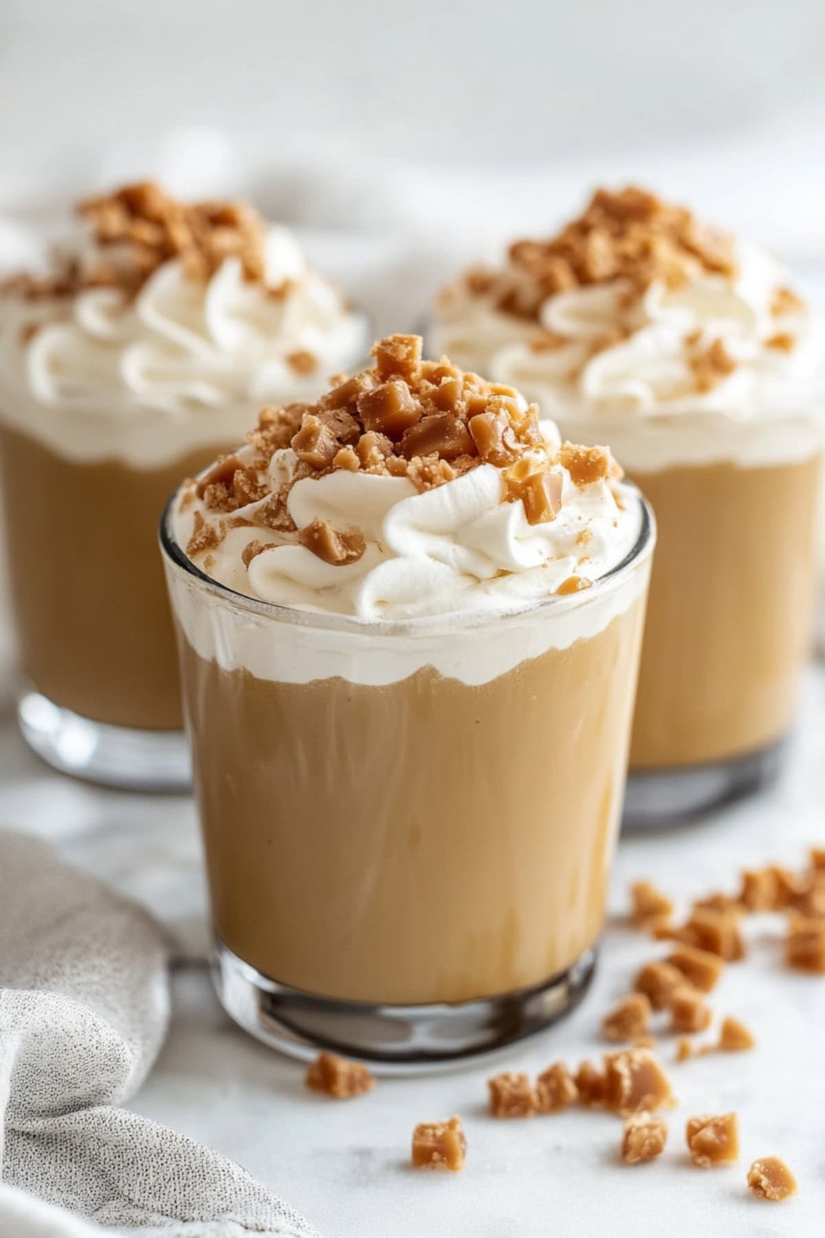 Homemade Butterscotch Pudding with whipped cream and toffee pieces