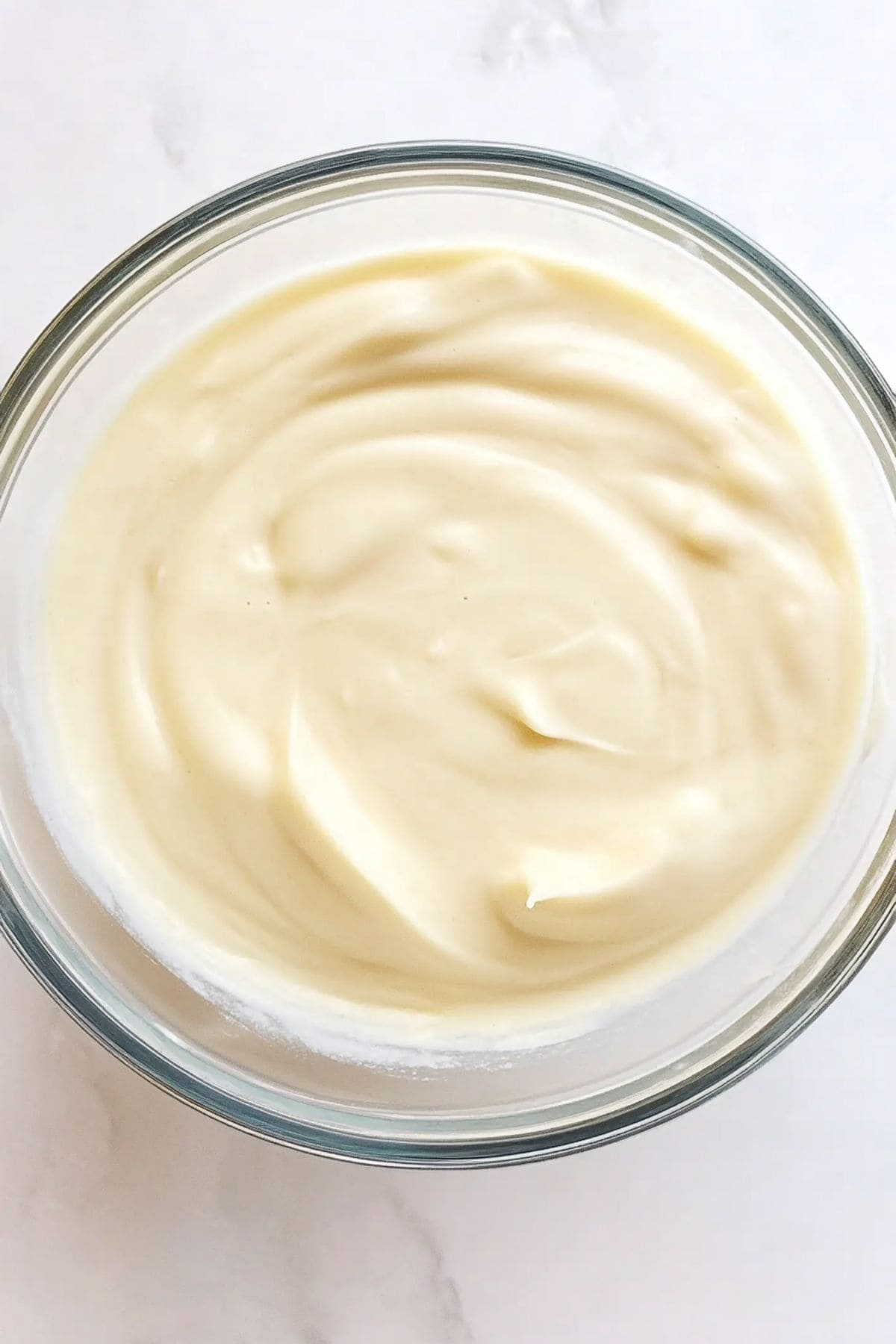 Vanilla pudding in a glass bowl.