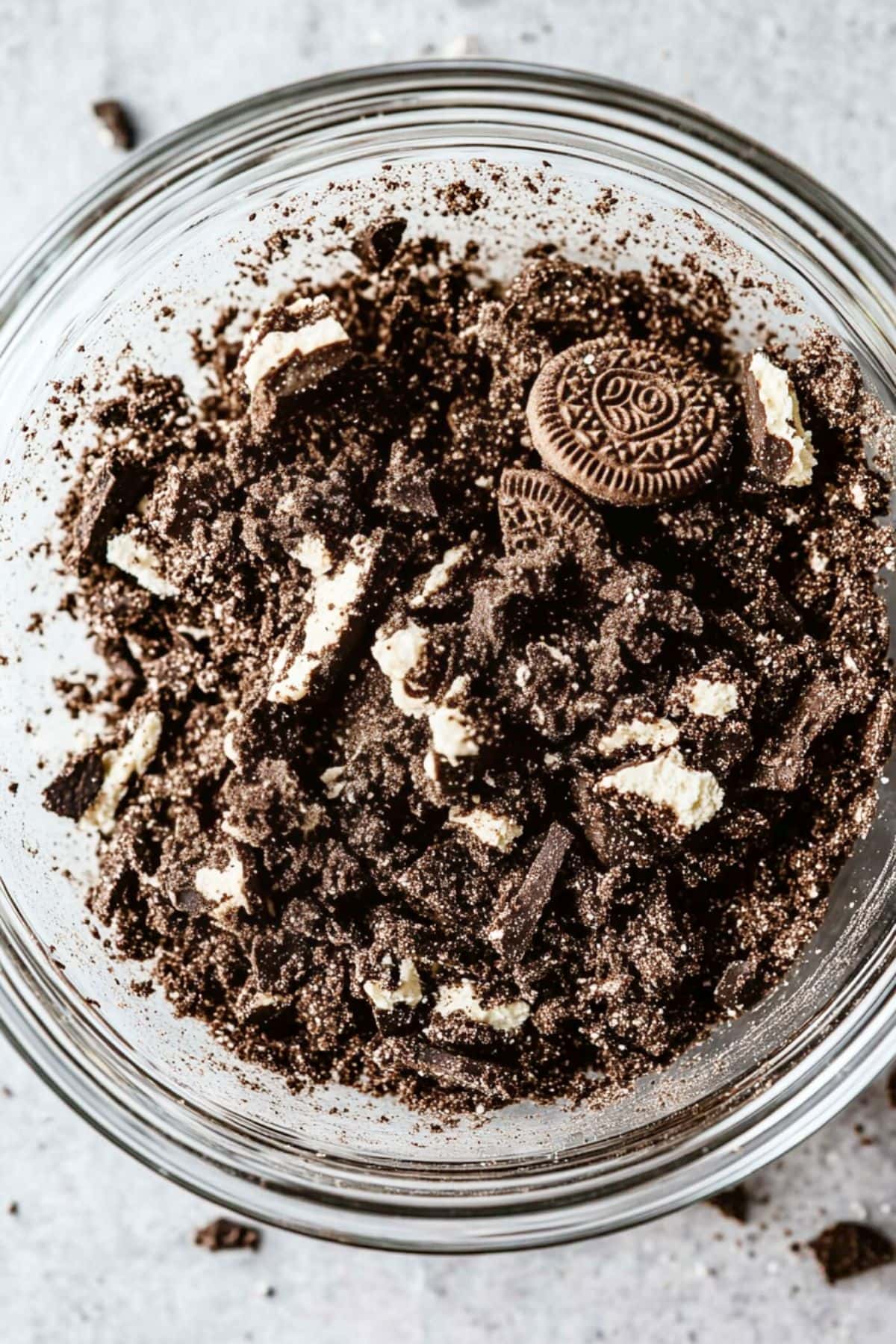 Crushed oreos in glass bowl.