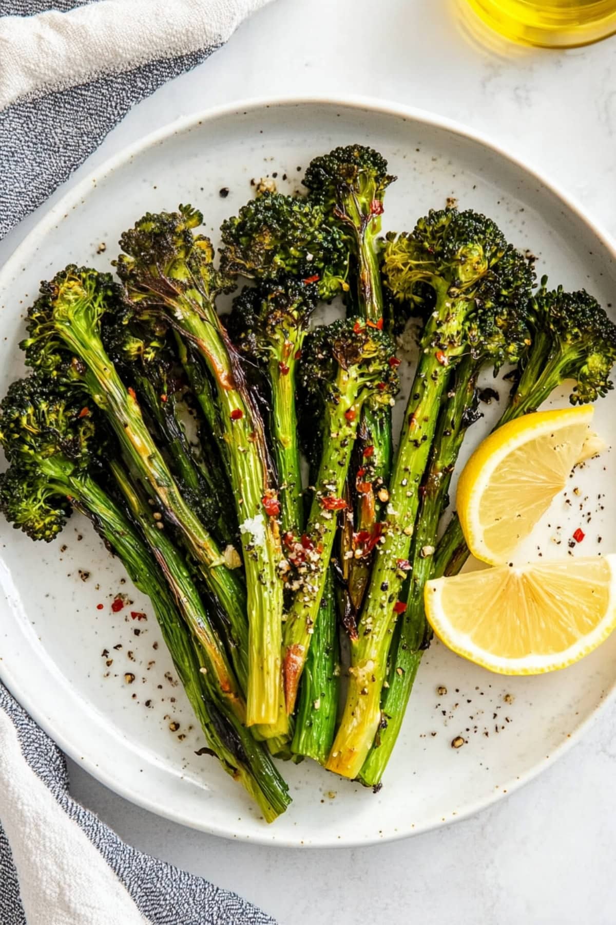 A close-up of roasted broccolini with crispy edges and a light drizzle of olive oil.