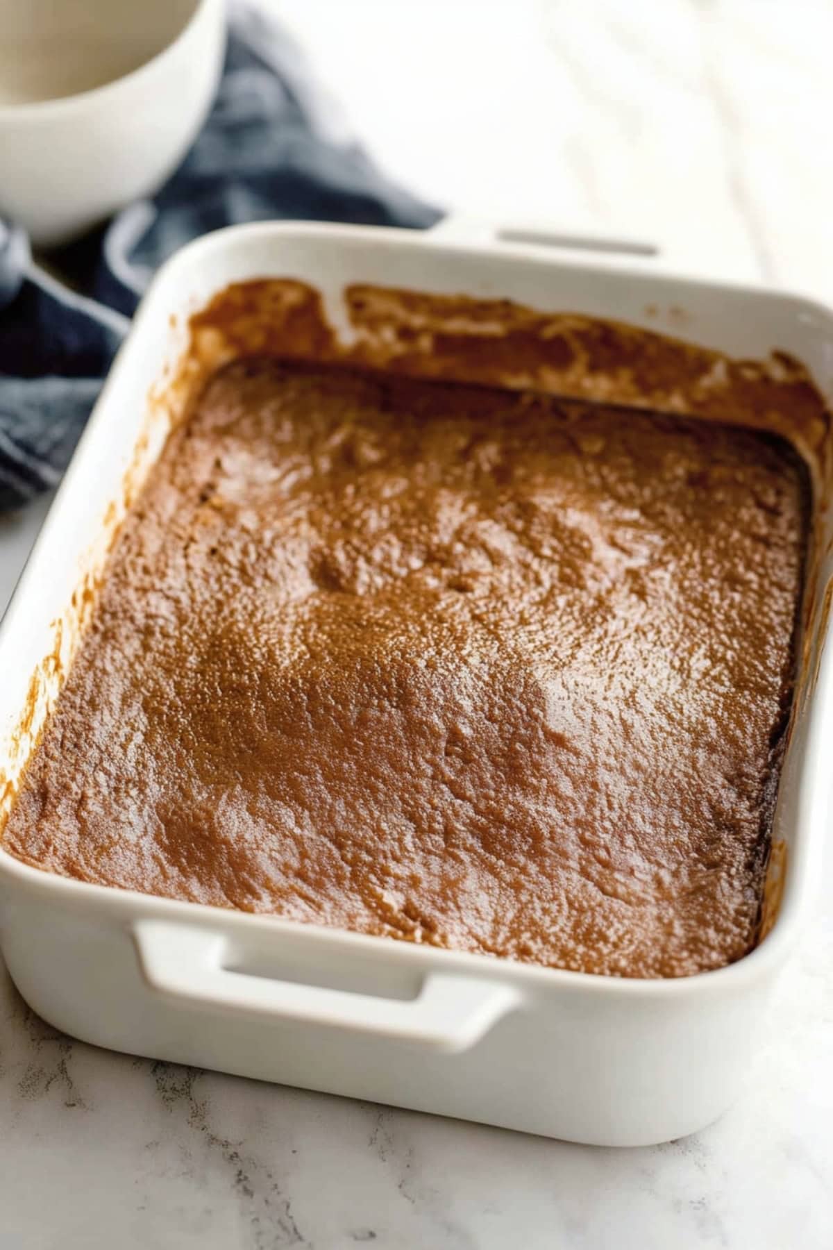 A baking dish of creamy indian pudding.