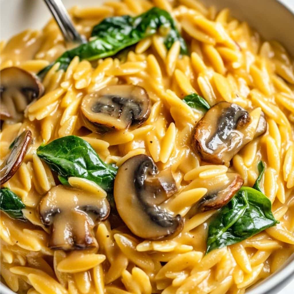 Mushroom orzo with spinach served in a bowl. 