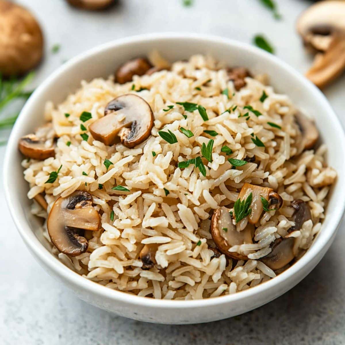 Mushroom rice served in a white bowl.