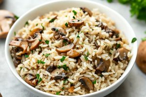 Mushroom rice served on a white bowl.