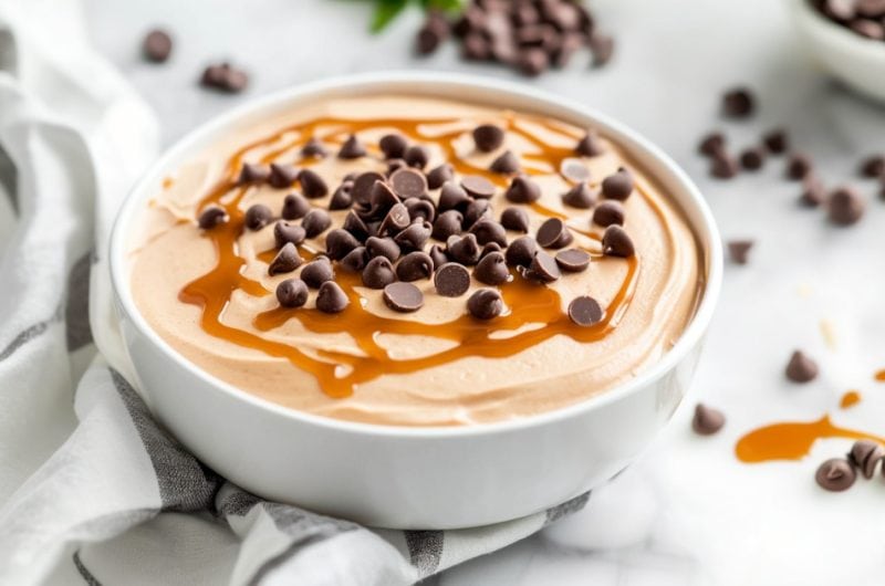 Peanut Butter Fluff recipe in a white bowl with caramel and chocolate chips