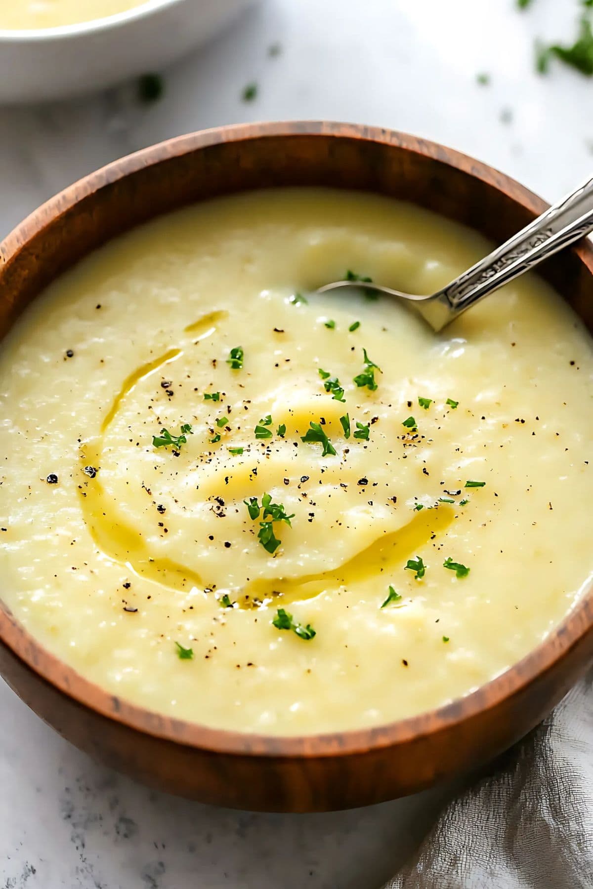 Potato leek soup seved in a wooden bowl.