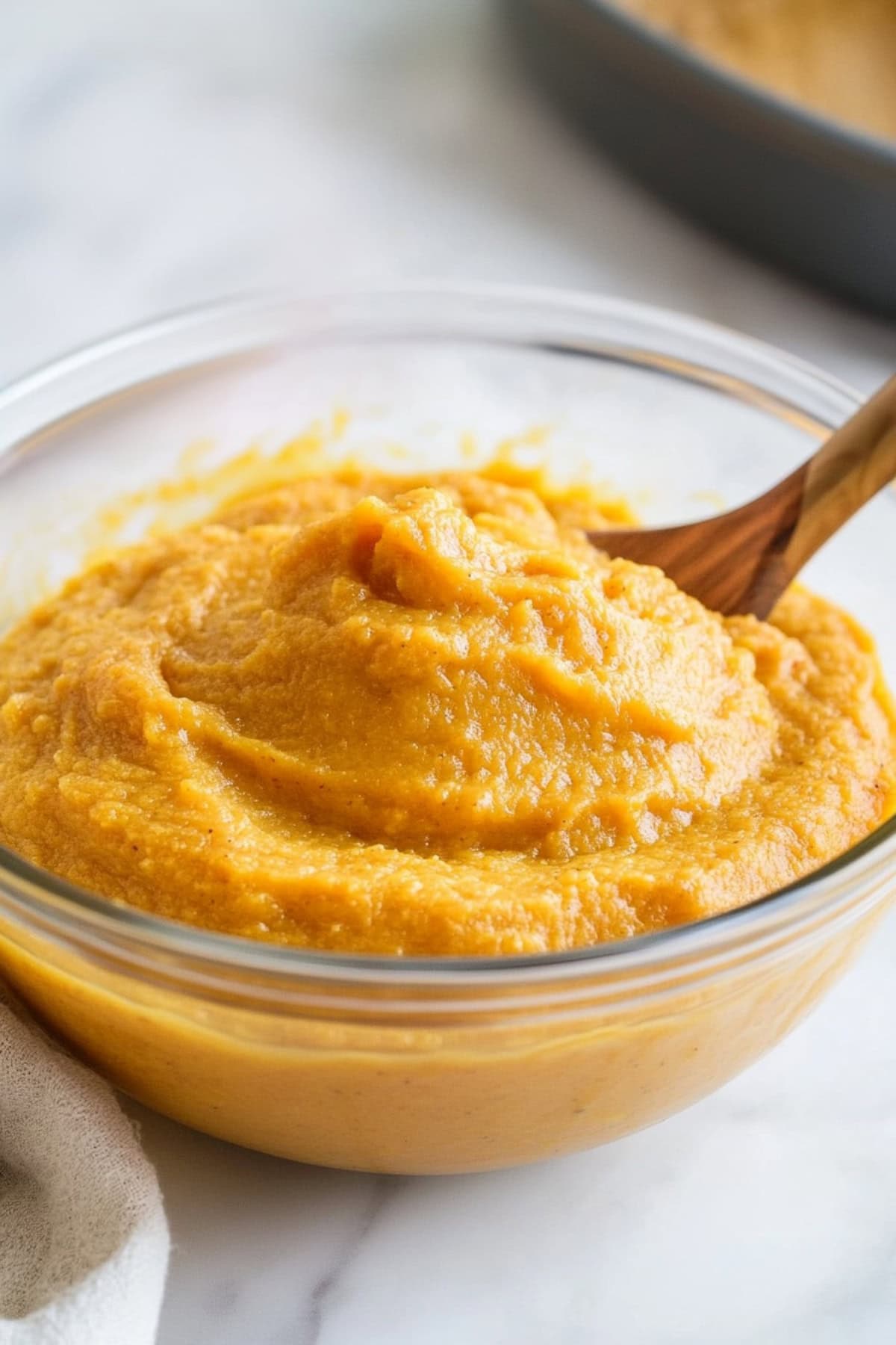 Creamy pumpkin puree in a glass bowl.