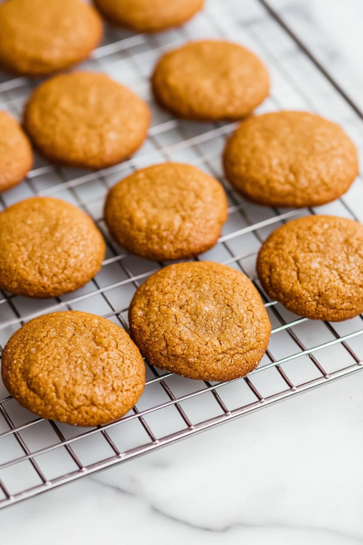 A cooling rack filled with pumpkin whoopie pies.