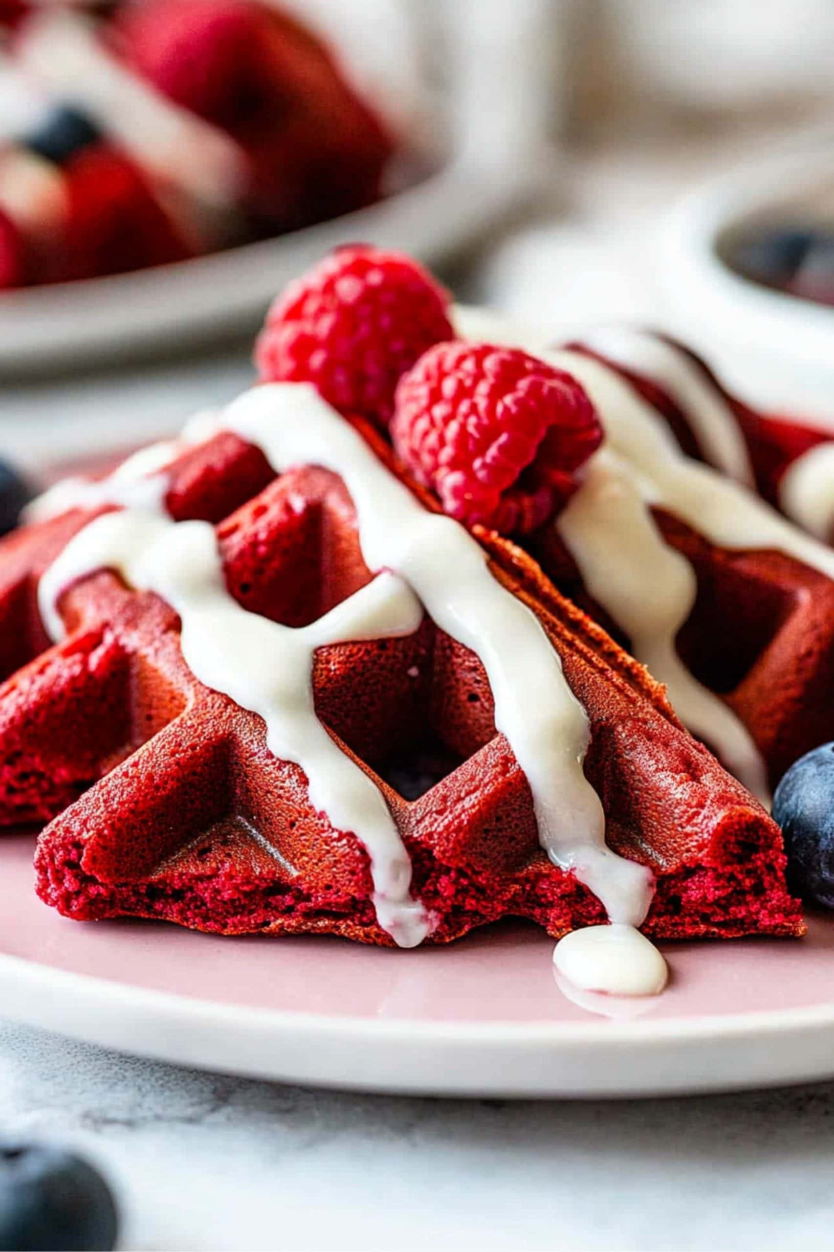 Red Velvet Waffle Slices with Fresh Raspberries and Cream Cheese Glaze.