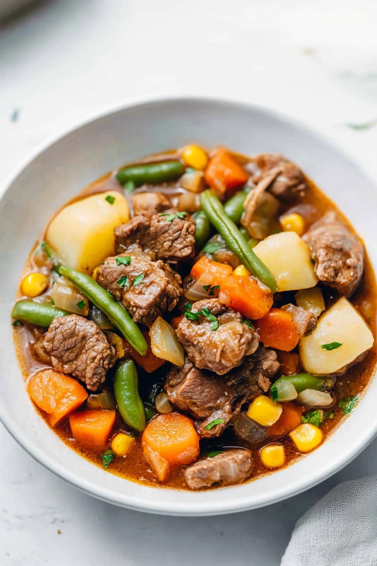 A comforting bowl of mulligan stew showcasing beef, carrots, and potatoes.