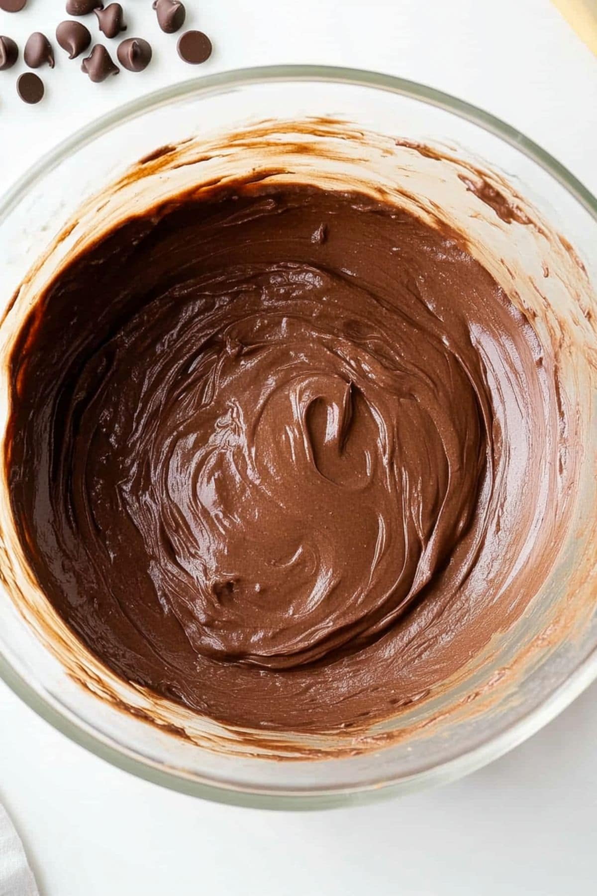 Brownie batter in a glass bowl, top view