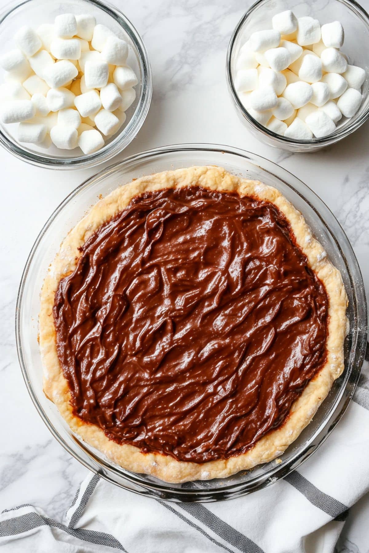 Baked pizza dough with nutella spread on top, top view