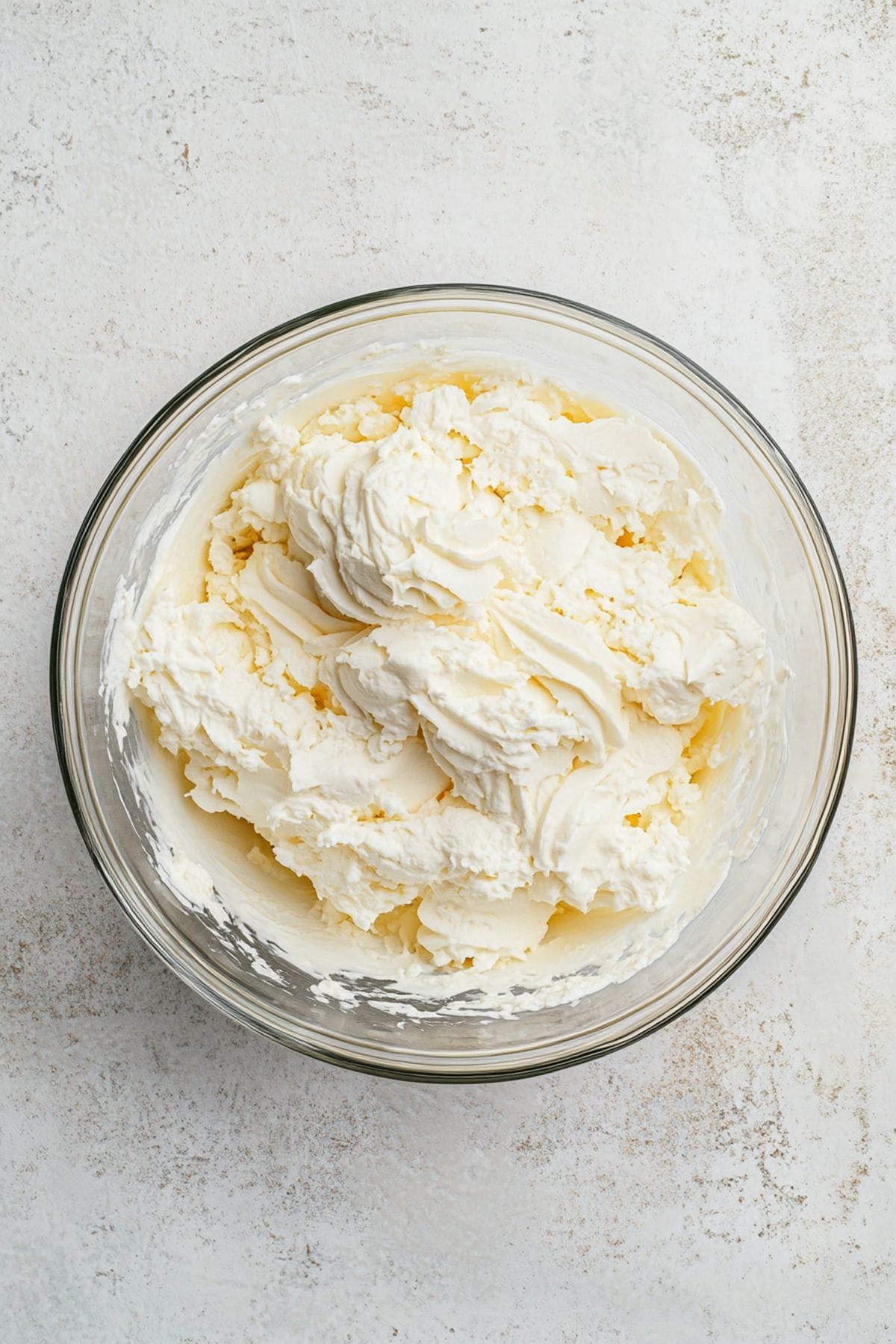 Cheesecake filling in a glass bowl.