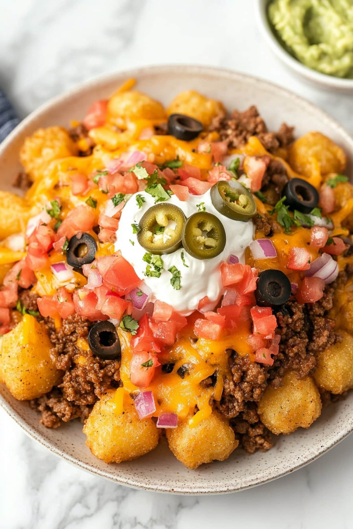 Totchos: Tater tots with ground beef, black olives, onions, pico de gallo, sour cream and cheese.