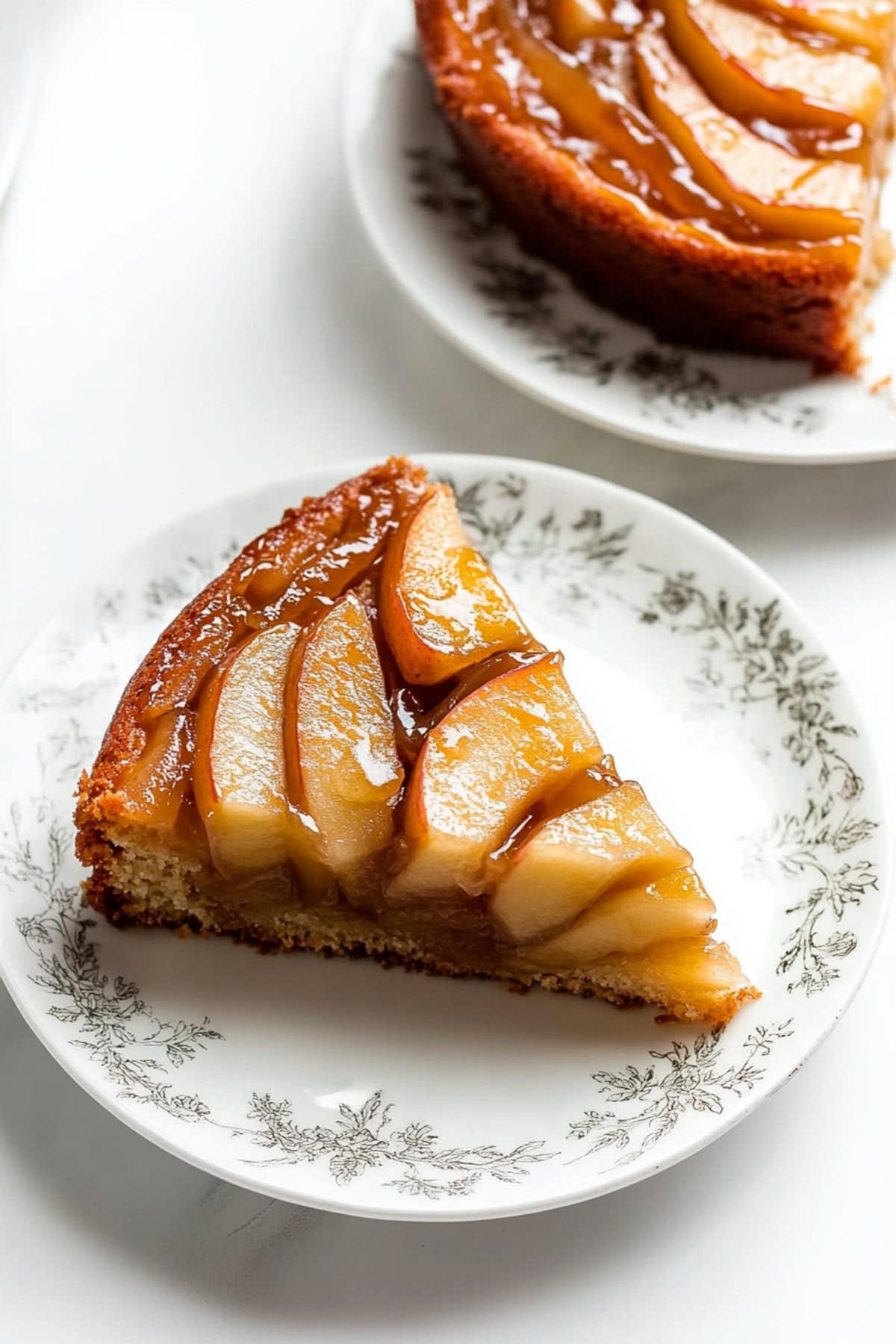 Slices of apple upside down cake served on plates. 