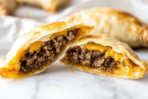 Homemade ground beef empanadas with melted cheese.