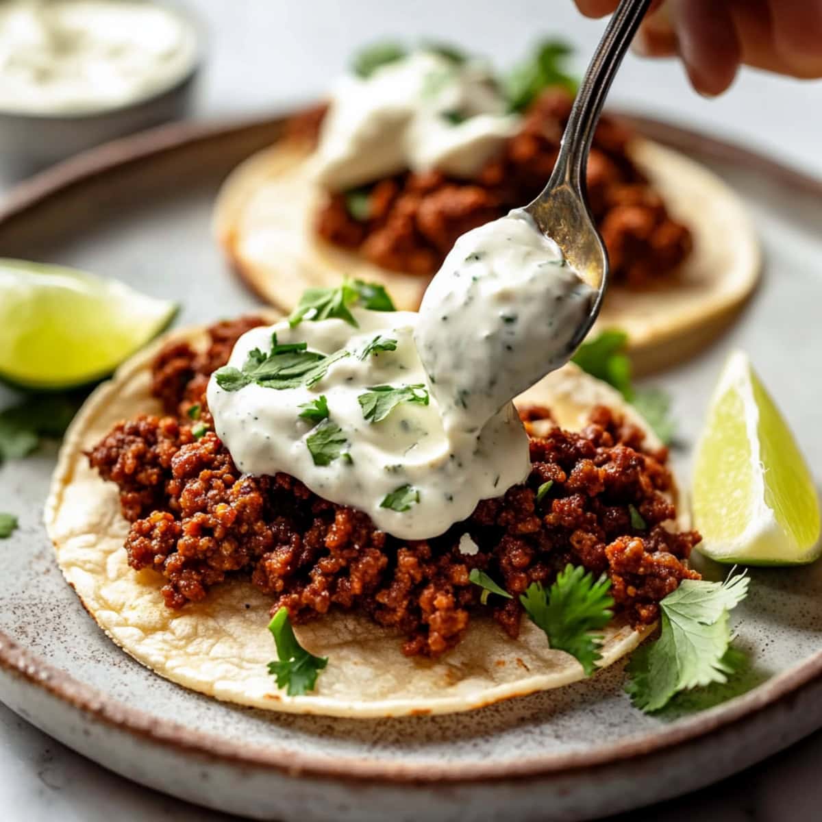 Chorizo tacos topped with creamy herb dressing and chopped cilantro