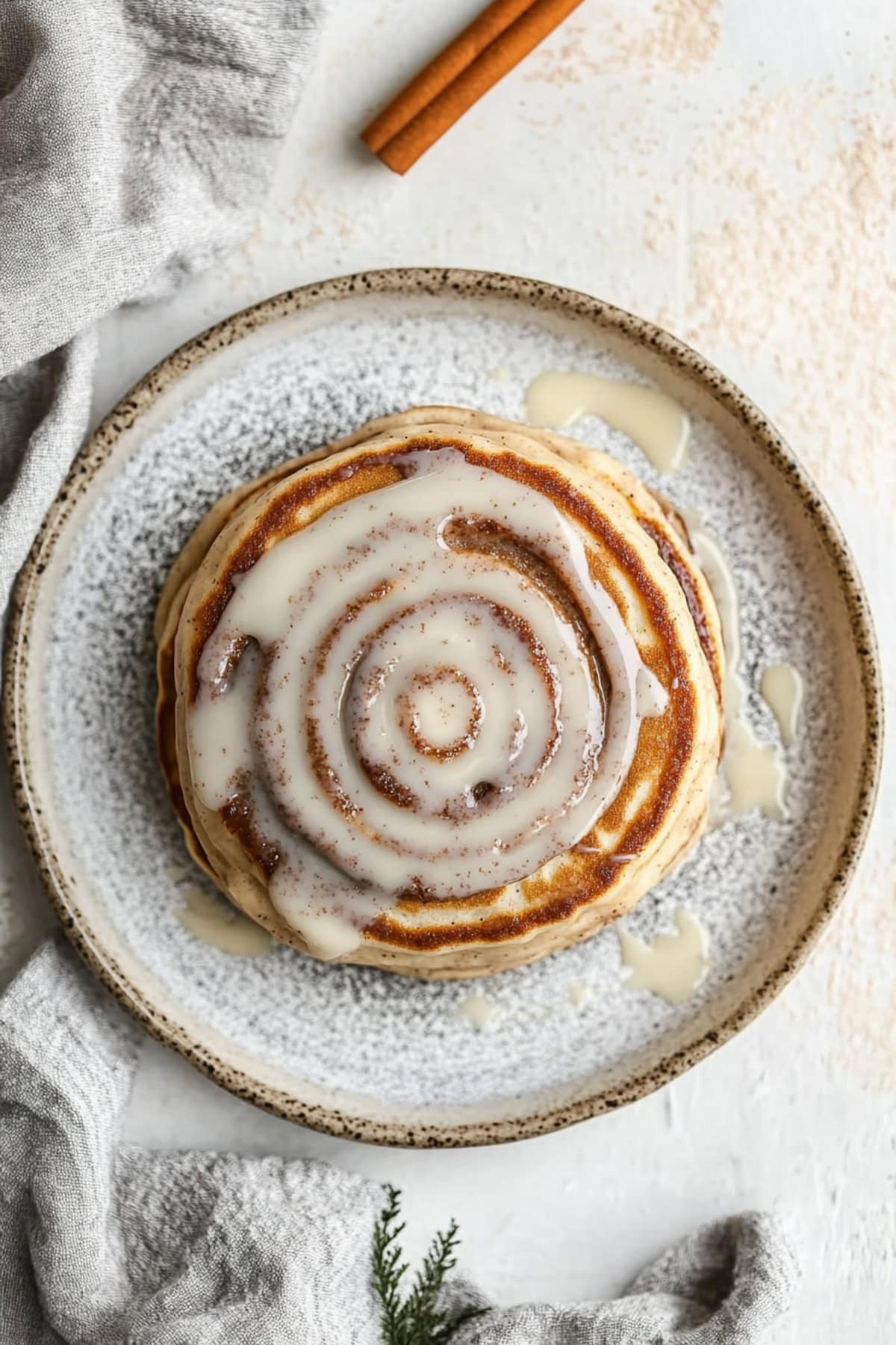 Cinnamon swirl pancakes with cream cheese glaze, top view