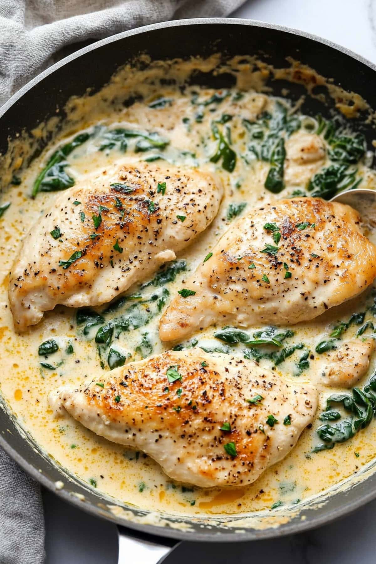 Chicken breast cooked with creamy Boursin cheese sauce and baby spinach.