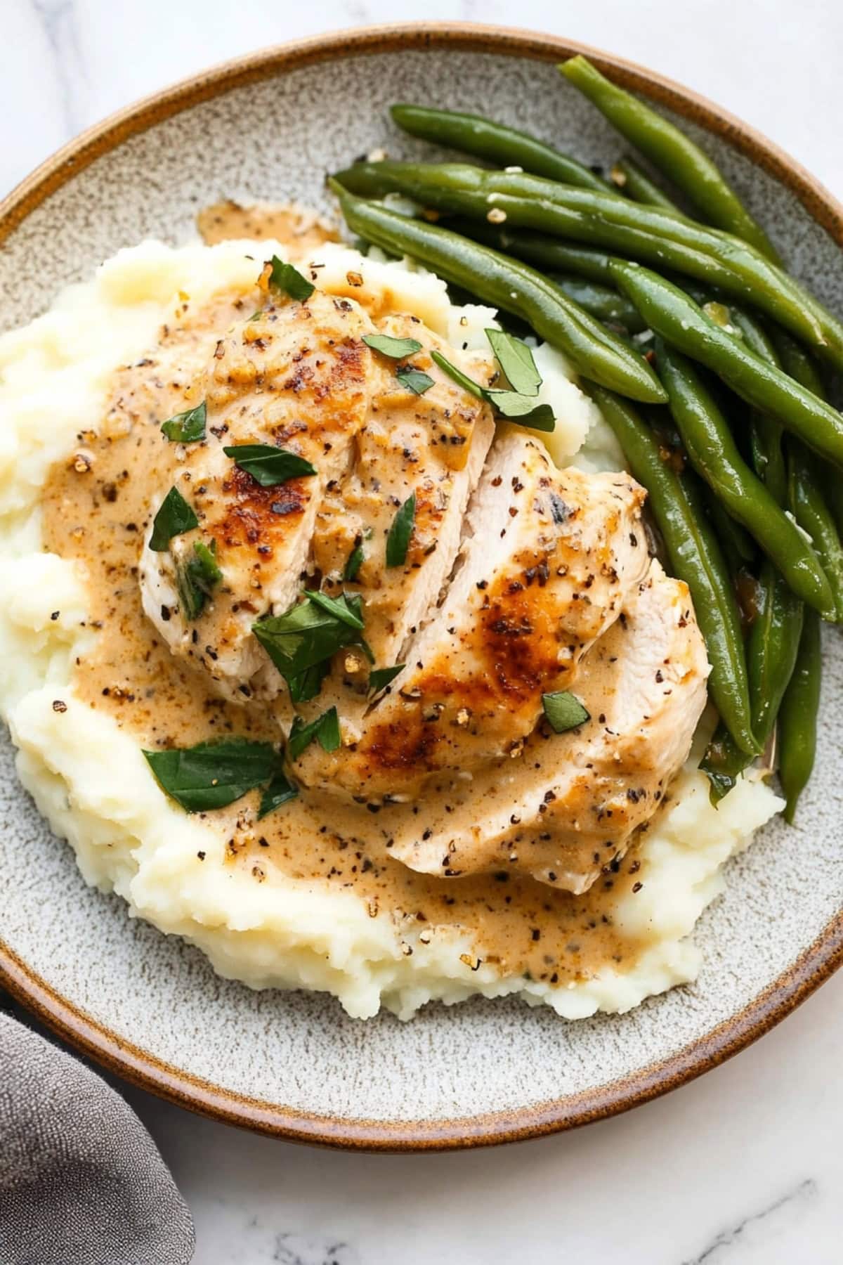 Creamy boursin chicken served on top of mashed potato with asparagus on the side. 