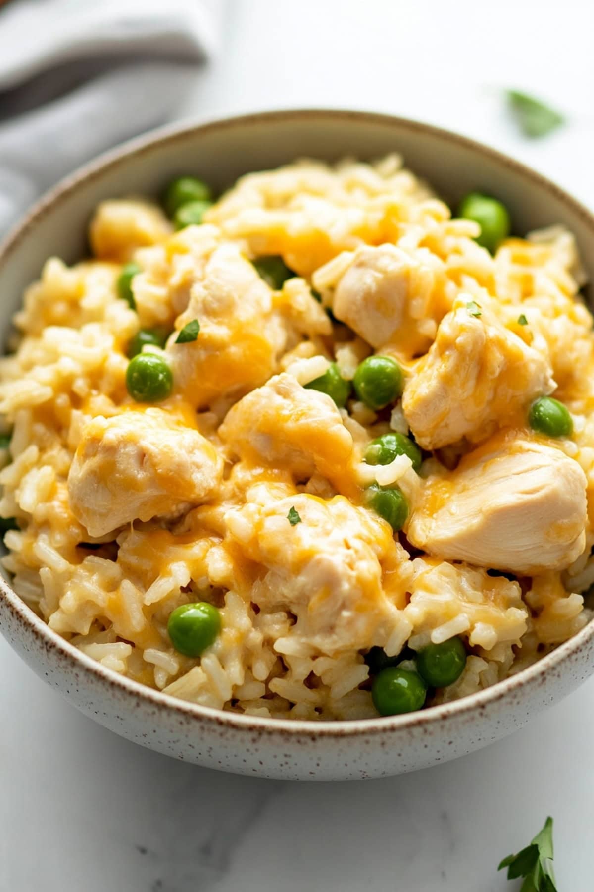 Cheesy and creamy chicken and with green peas in a bowl.