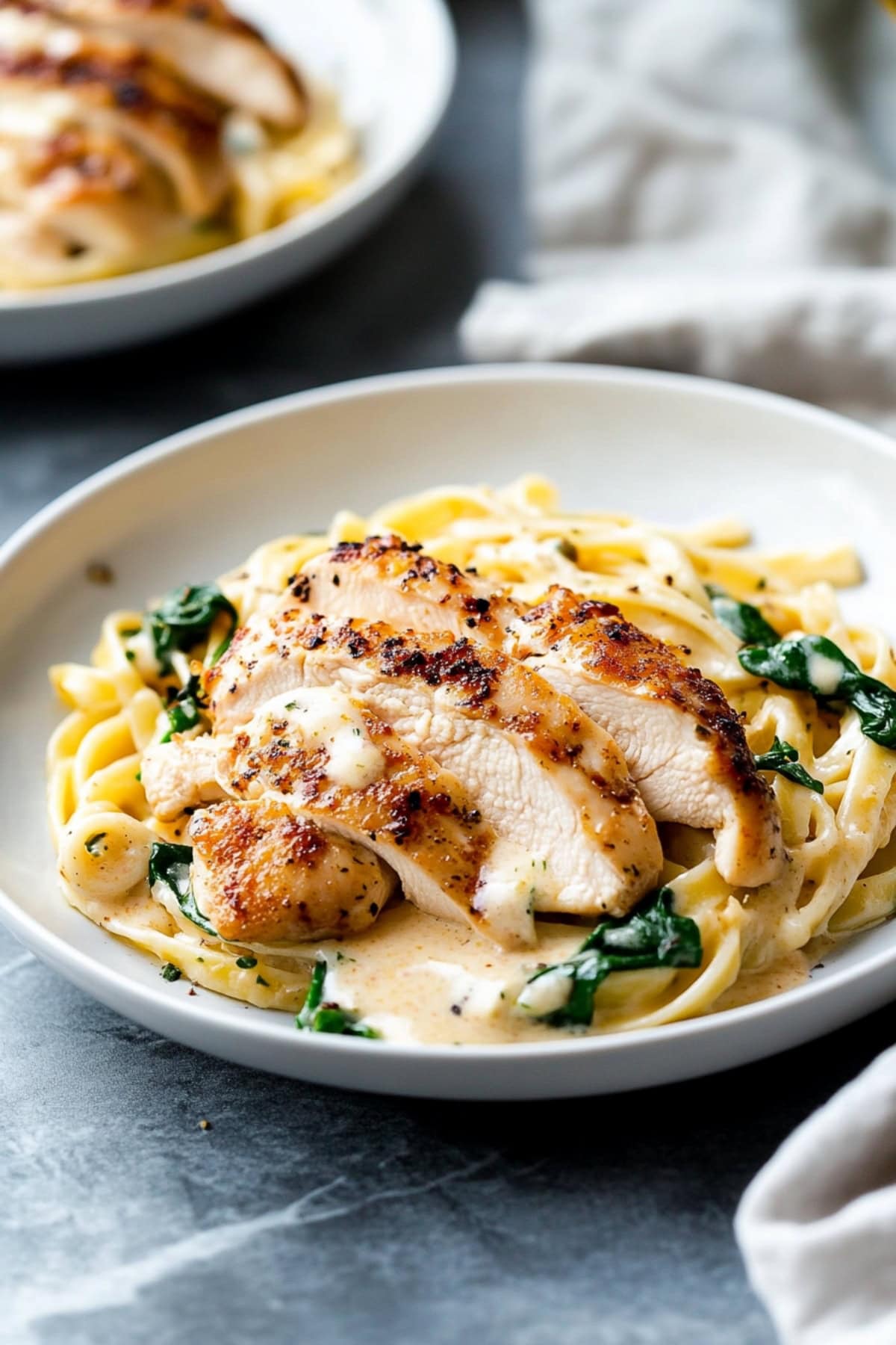 Serving of pasta with creamy chicken floremtine in a plate.