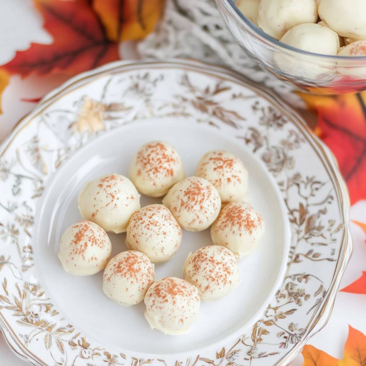 Bite-sized no-bake pumpkin cheesecake balls, sprinkled with cinnamon, top view