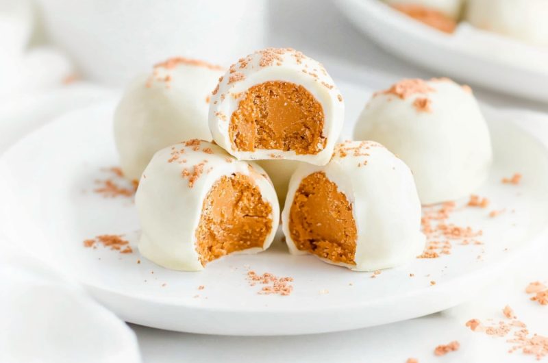 A plate of creamy no-bake pumpkin cheesecake balls with a hint of cinnamon.