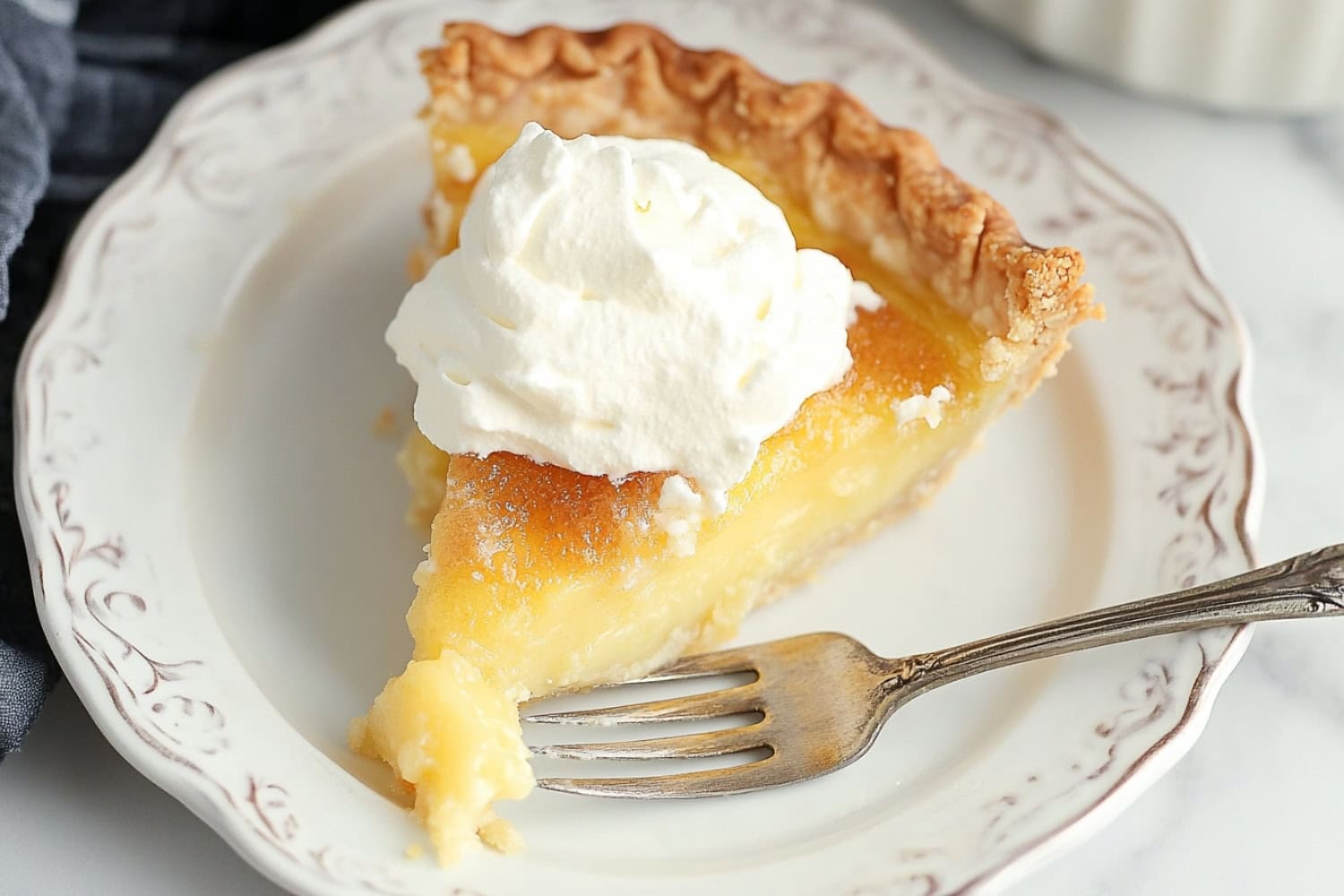 Old Fashioned Vinegar Pie On a plate with whipped cream