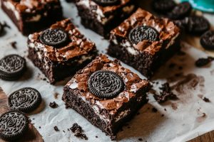 Freshly baked oreo brownies on a parchment paper.