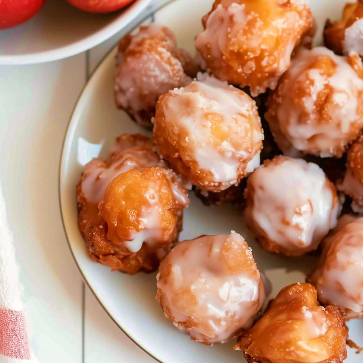 Apple Fritter Bites on a plate, close-up overhead shot.