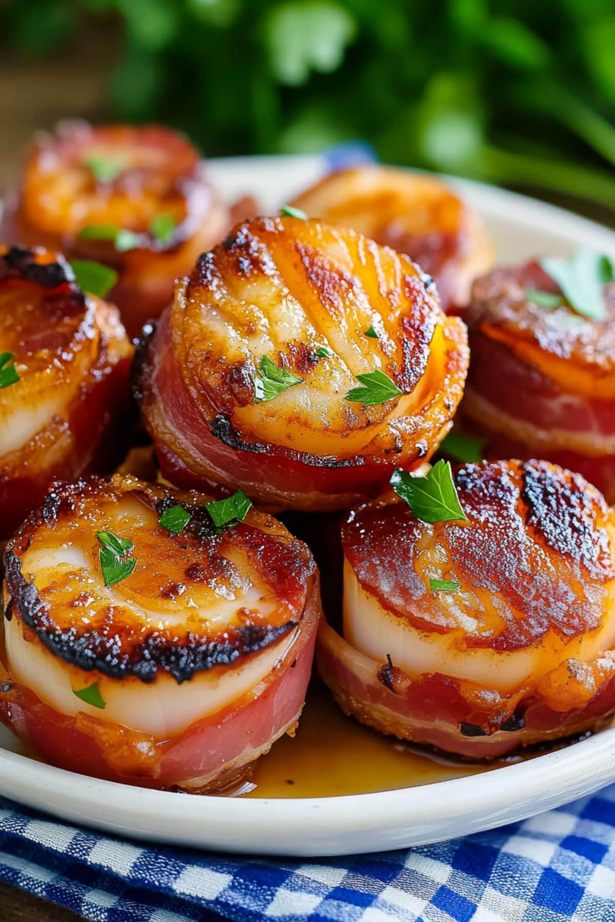 Bunch of bacon wrapped scallops in a white plate.