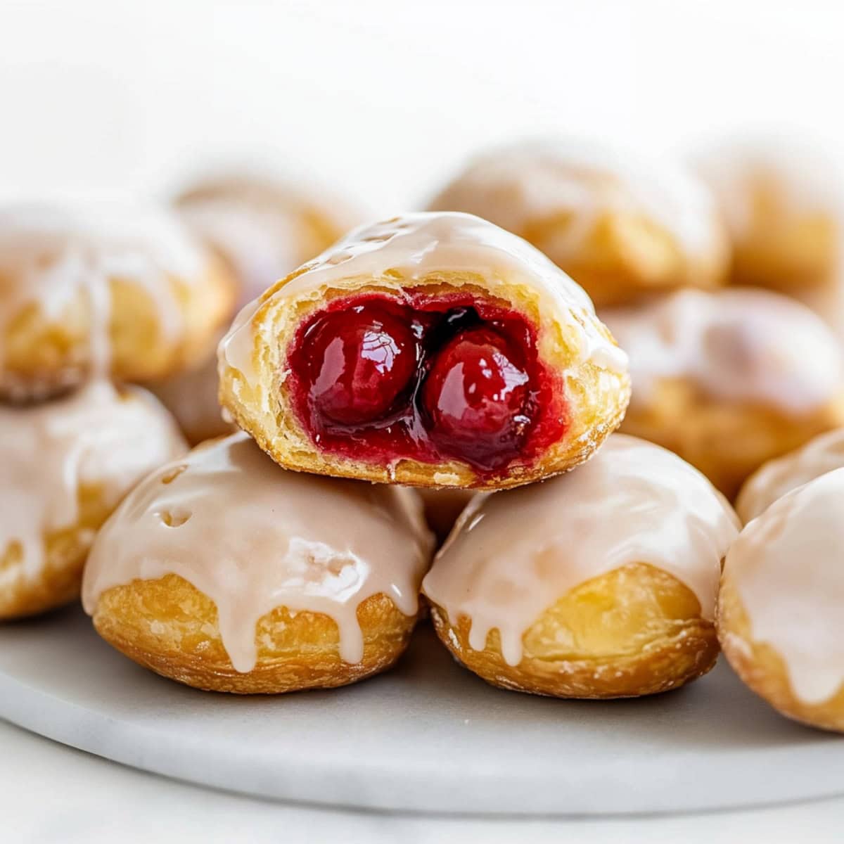 Flaky biscuits filled with cherry pie filling, covered in vanilla glaze.