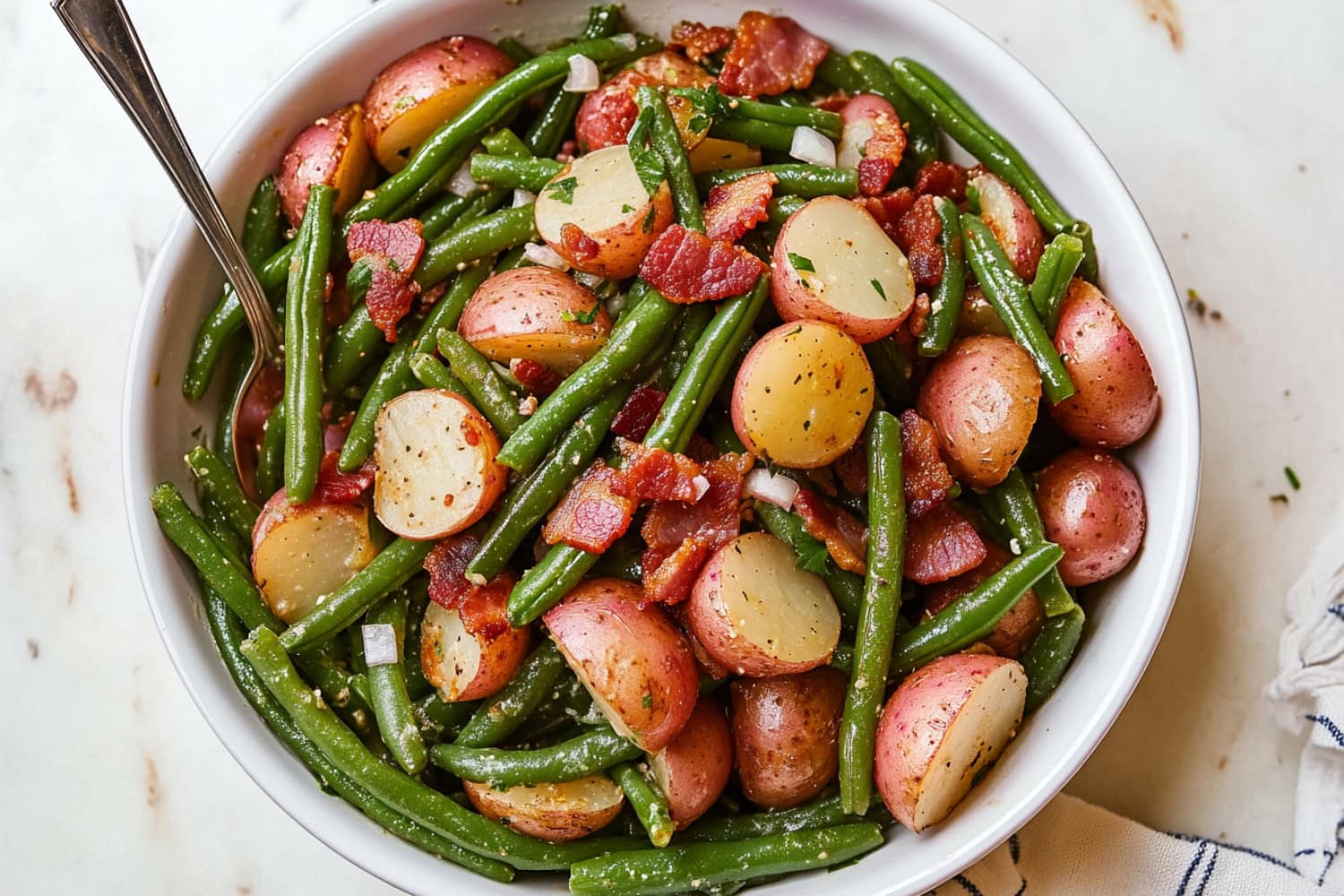 A healthy meal featuring sautéed green beans and red potatoes in a bowl.