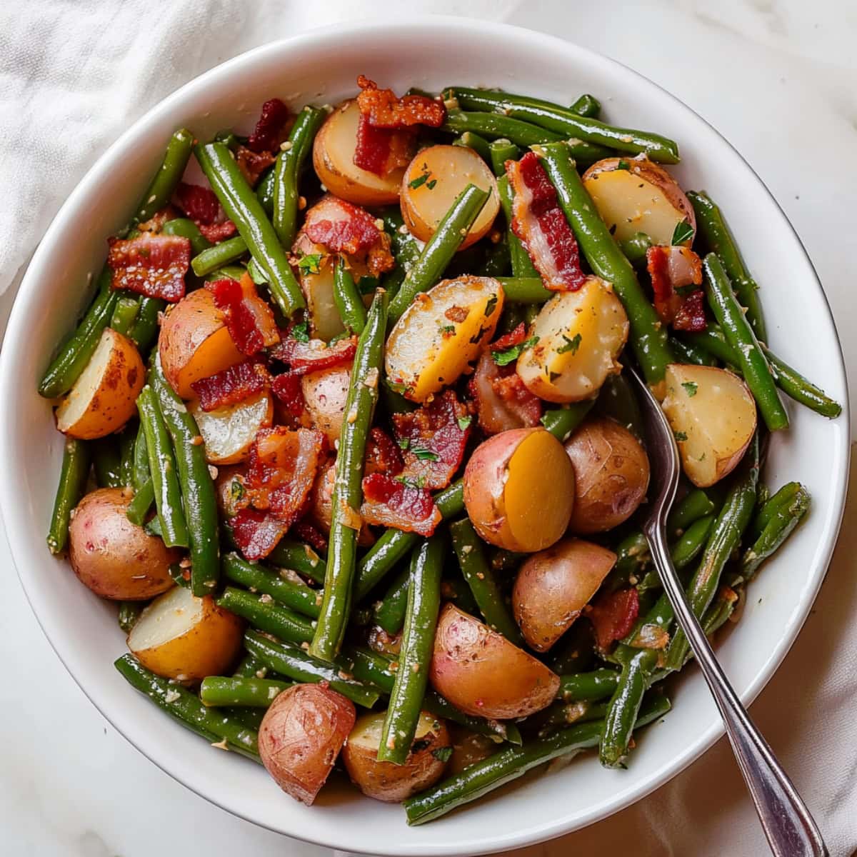 An overhead view of Country Ranch style green beans and potatoes with bacon in a bowl.