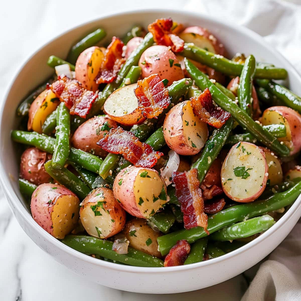 Southern green beans and potatoes with white onions and crispy bacon.