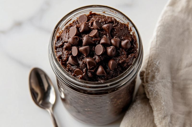 Close-up of creamy edible brownie batter featuring a smooth texture and scattered chocolate chips.