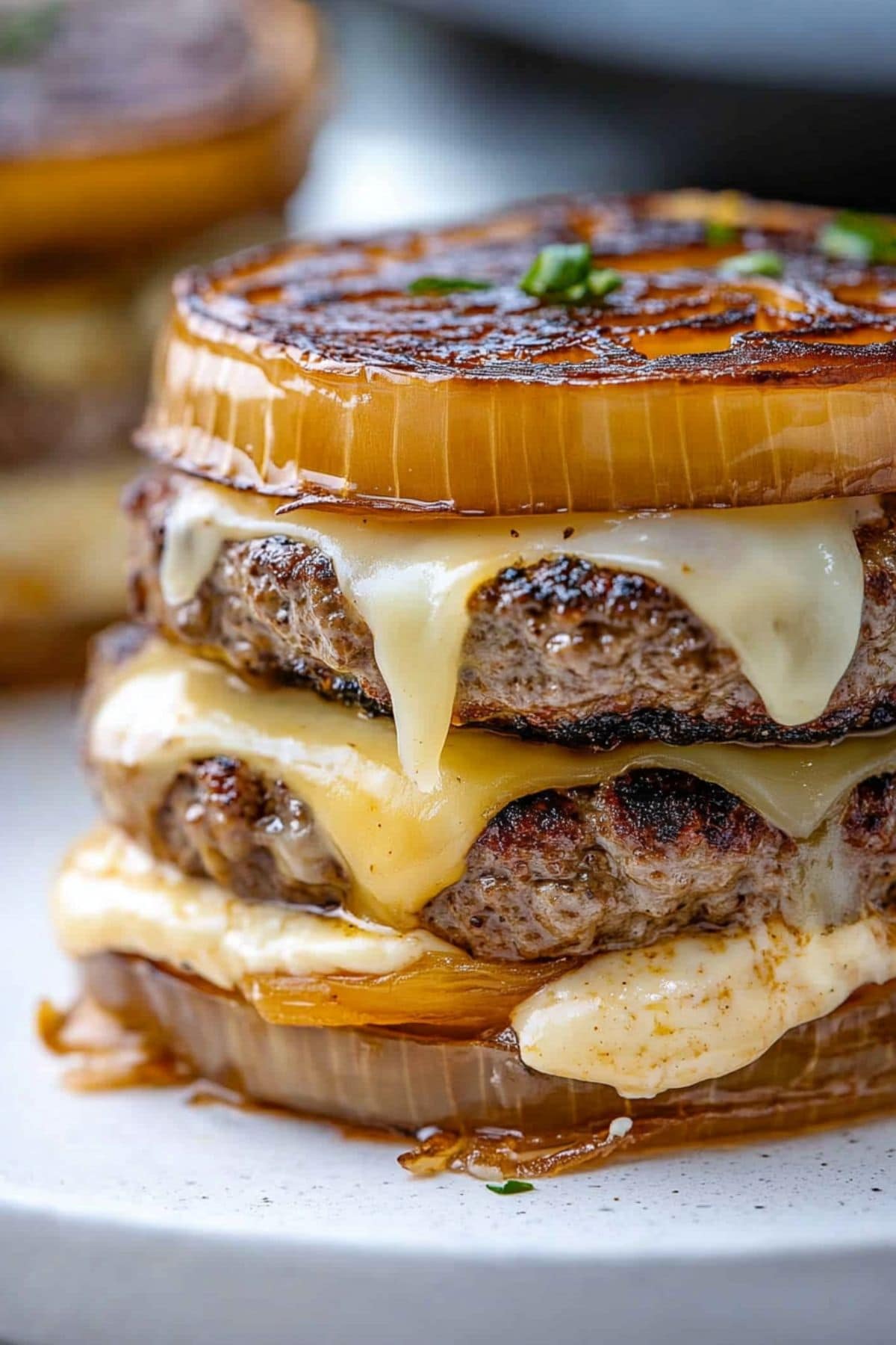 Flying Dutchman burger with melted cheese and thick patties inbetween caramelized onion rounds. 