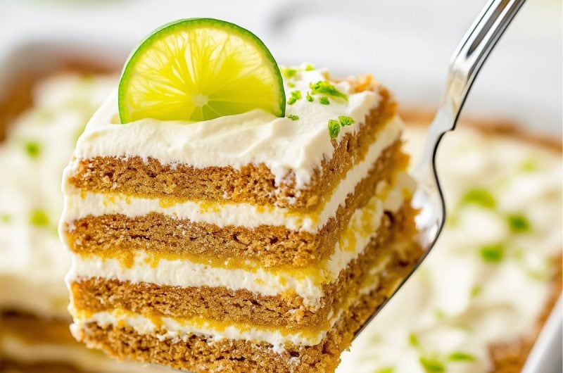 Pie ladle lifting a slice of key lime icebox cake from baking dish.