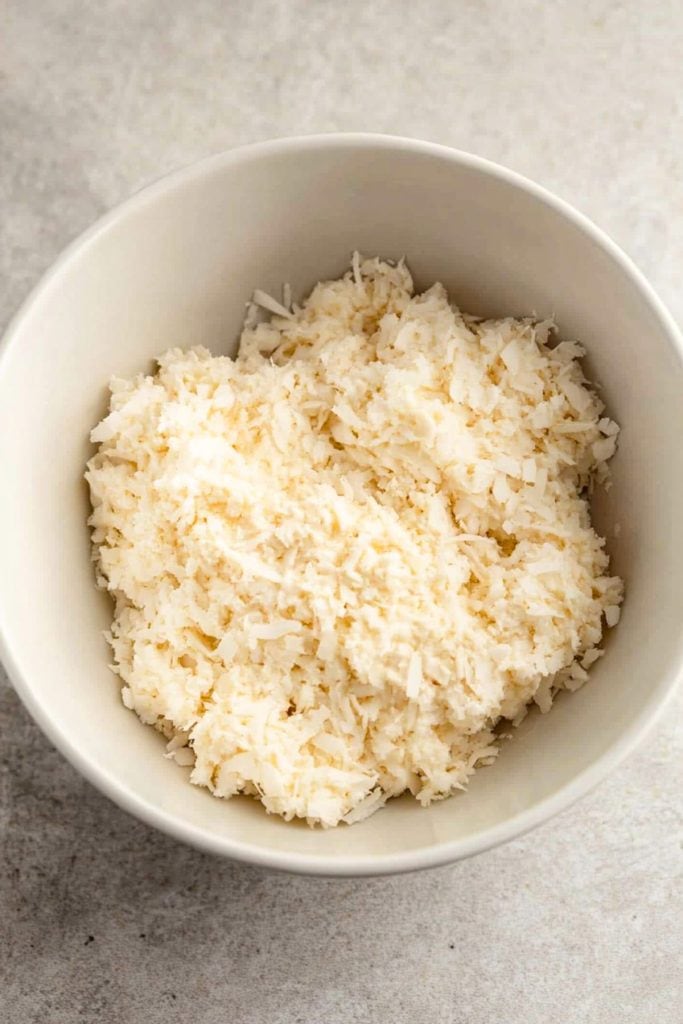 Creamy coconut Mounds filling in a white bowl, top view